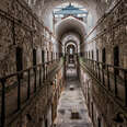 A daytime interior shot of Eastern State Penitentiary, with crumbling walls