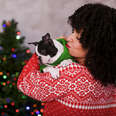 Woman hugging her puppy at Christmas time